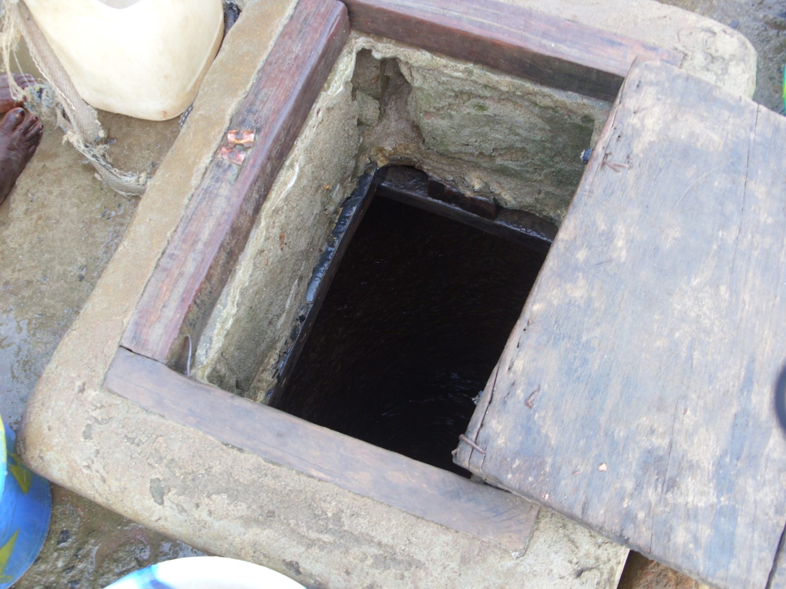 An unsafe open well used as a community drinking water source